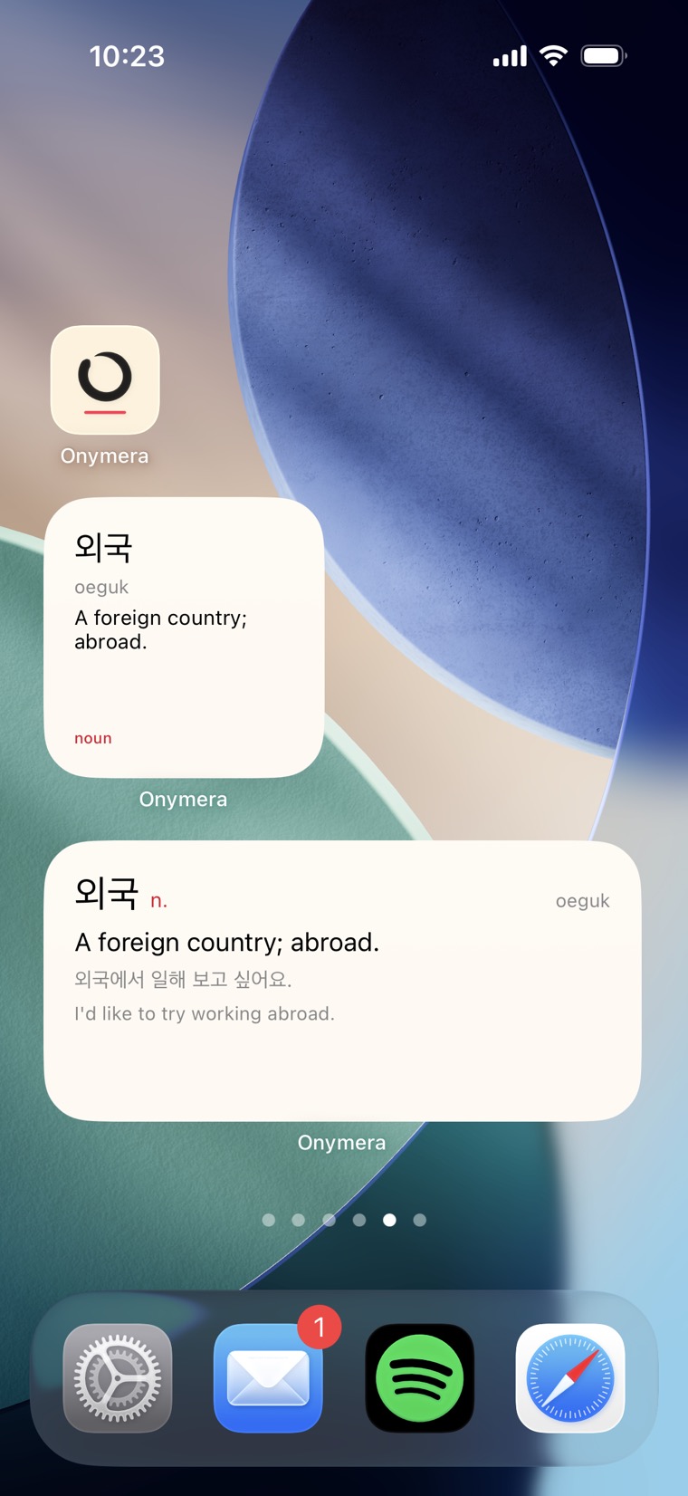 An iPhone home screen with the small and medium Onymera widgets, both showing the Korean word 외국, oeguk — a foreign country; abroad. The medium one adds the example sentence.